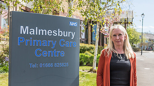 Roz Savage MP standing outside a dentist's.