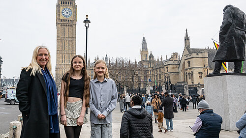 Roz Savage MP with aspiring young reports in front of Big Ben, London