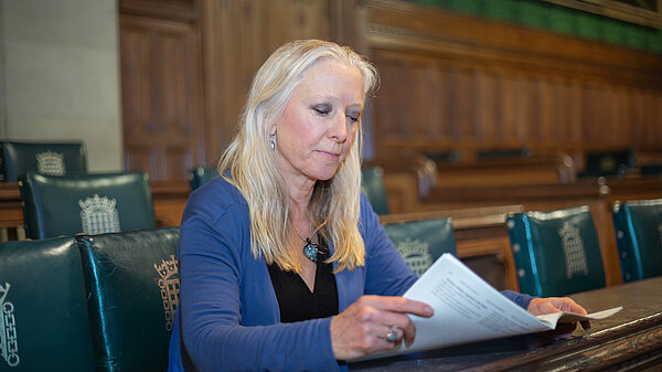 Roz Savage MP reading important documents in Parliament